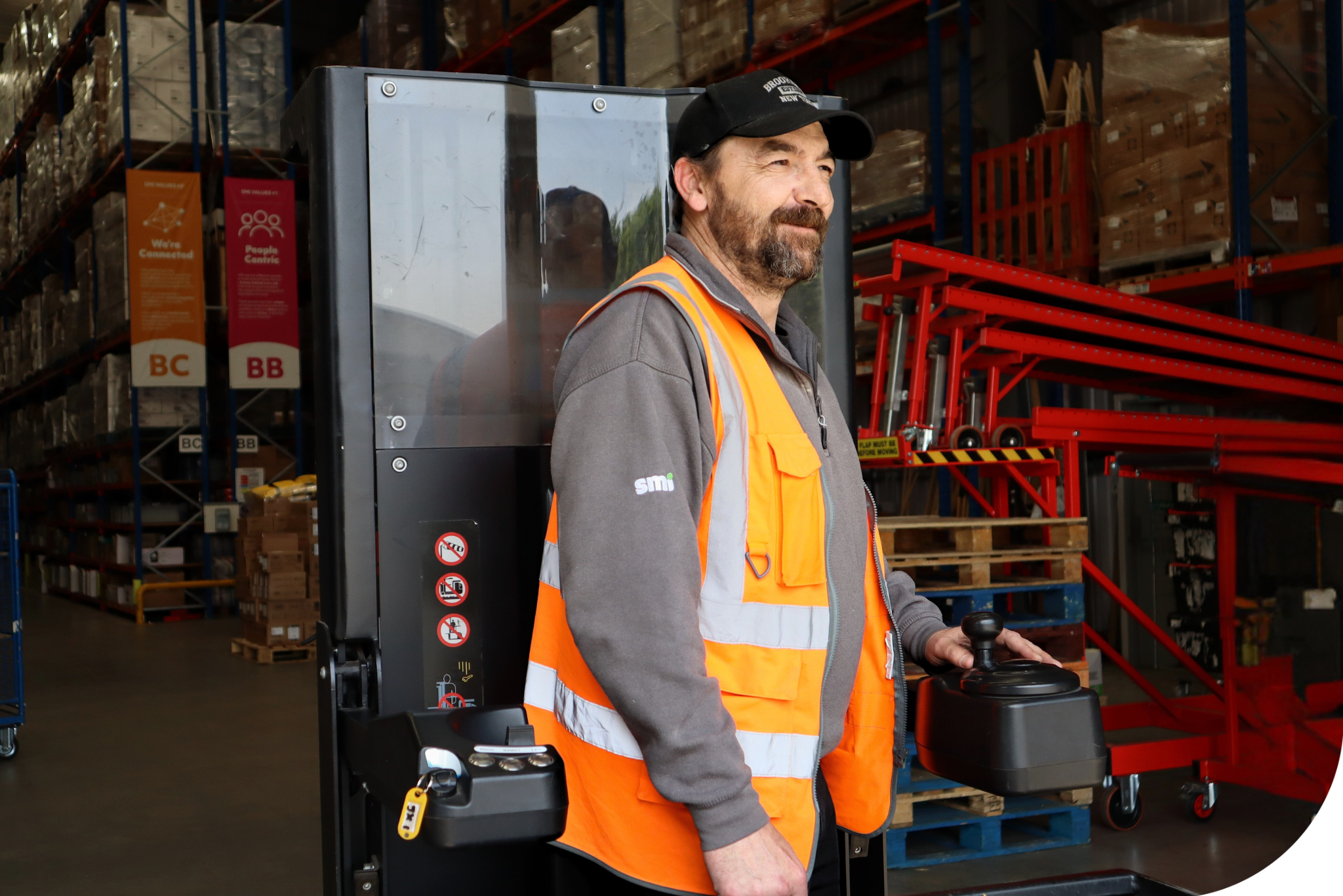 Man wearing hi-vis on a forklift.