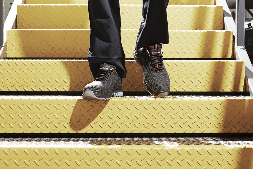 Person walking downstairs wearing Vulcan trainer shoes