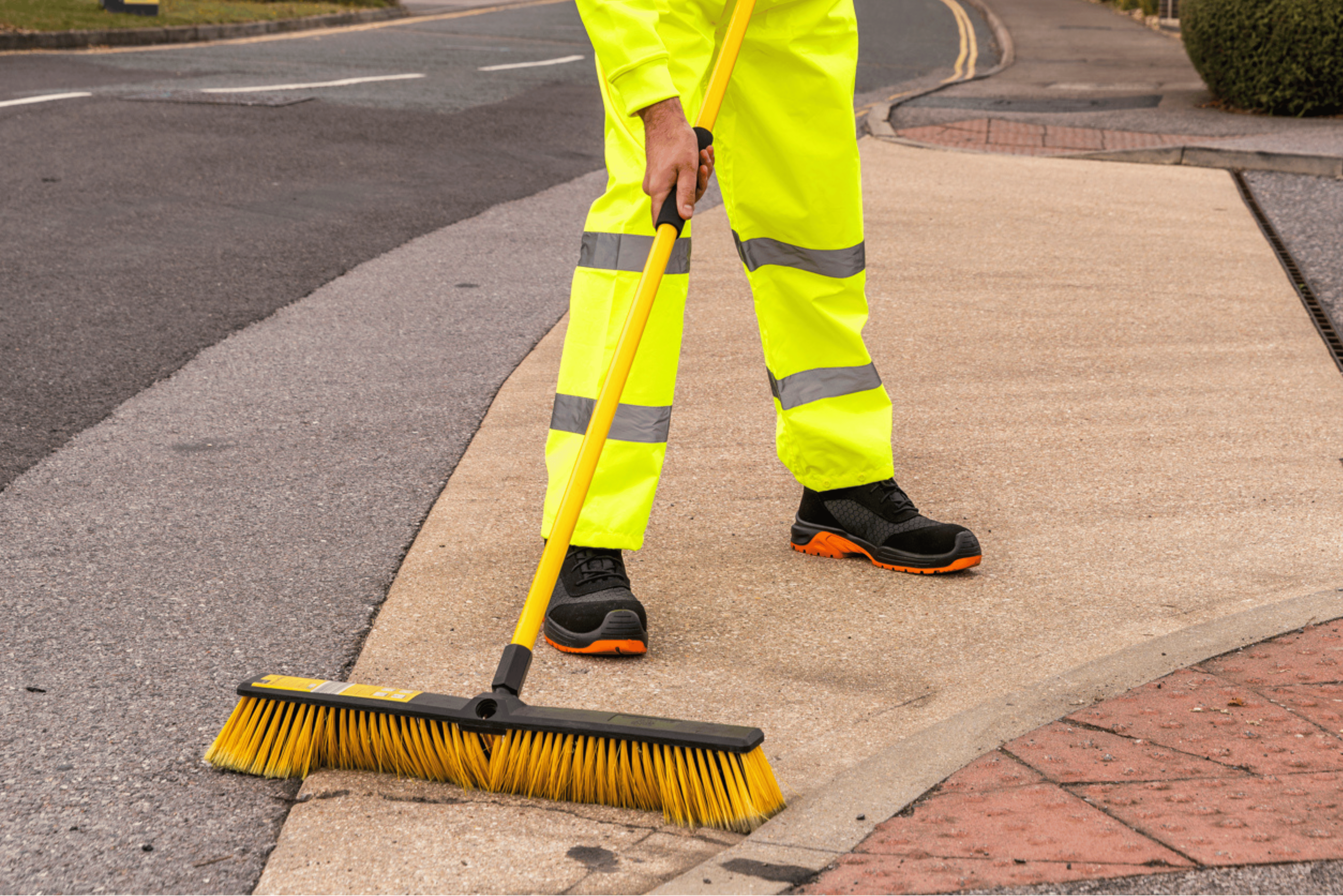Man wearing yellow hi-vis trousers and safety shoes.